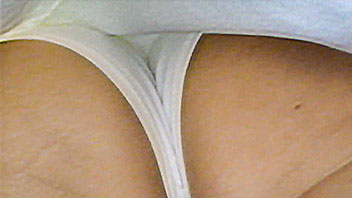 Ut_2045# Tanned brunette hottie in short white dress. Another cool model for upskirt pussy scene. Ni